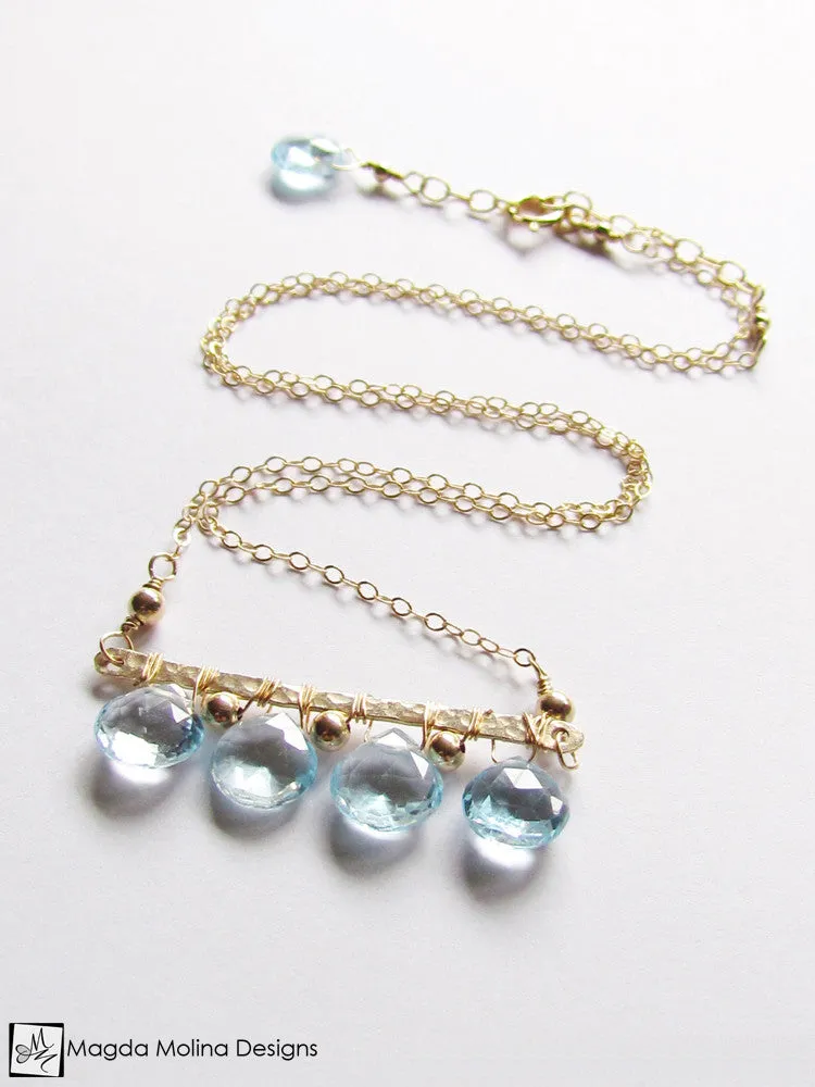 The Something Blue Necklace: Horizontal Hammered Gold And Blue Topaz Drops